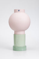 Two-toned ceramic vase with pink top and green bottom on a white background