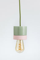 Pendant light with green and pink design on a white background