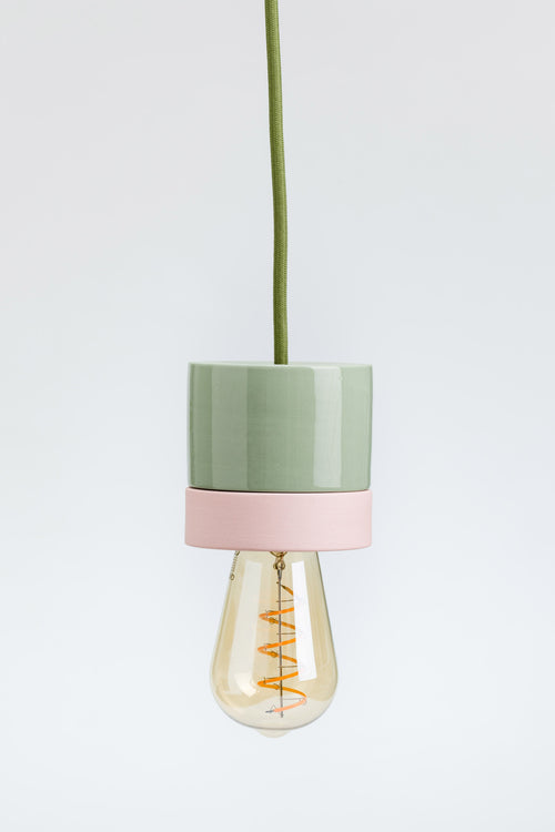 Pendant light with green and pink design on a white background