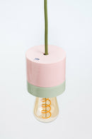 Decorative lamp with pink and green base on a white background