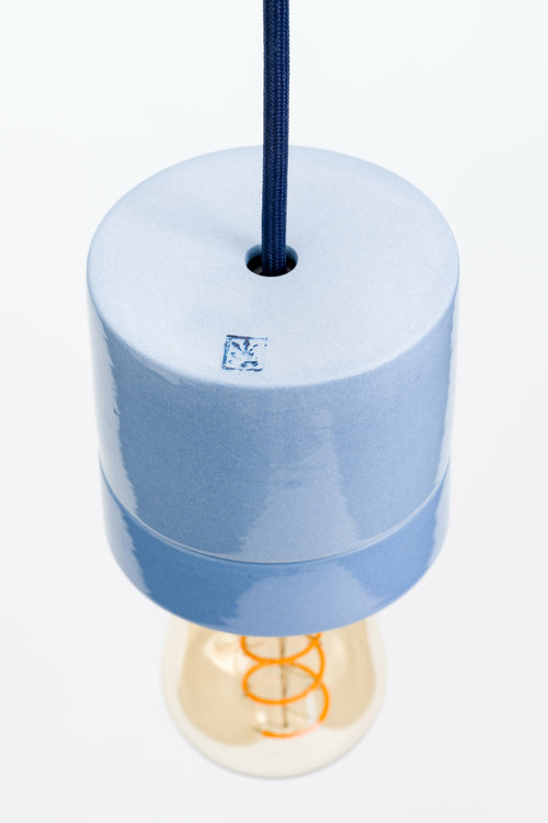 Blue pendant light with a visible brand logo on a white background