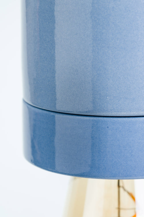 Close-up of a blue cylindrical container with a white background